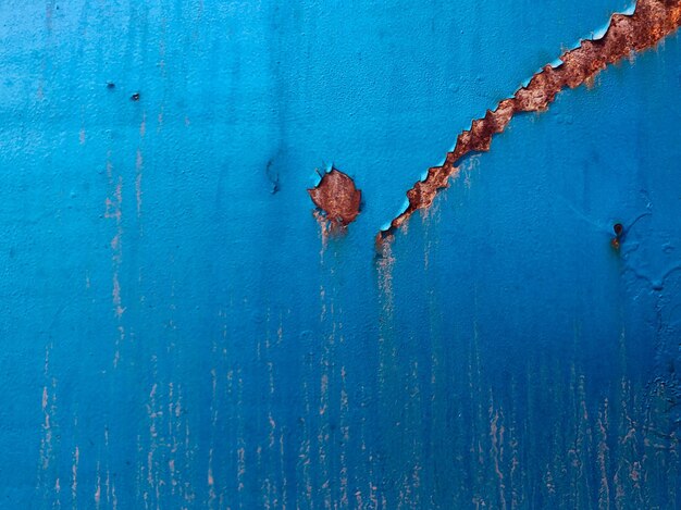 Scratched and rusted blue metal surface