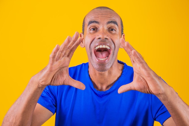 Screaming man with hands over mouth