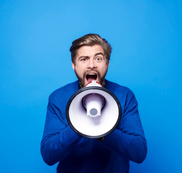 Screaming man with megaphone shouting