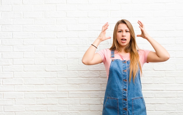 screaming with hands up in the air, feeling furious, frustrated, stressed and upset