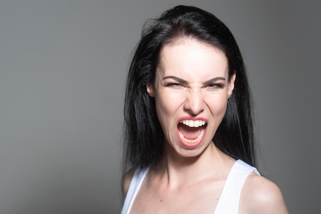 Screaming woman emotional portrait face expression human emotions shout isolated