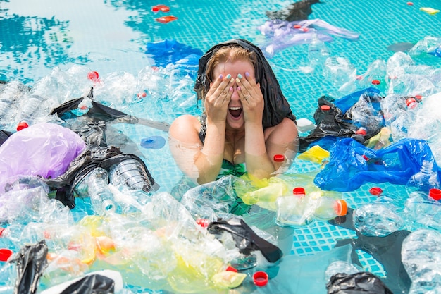 Screaming woman with a plastic bag over his head in a dirty swimming pool.