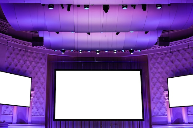 Screens in purple illuminated cinema theater