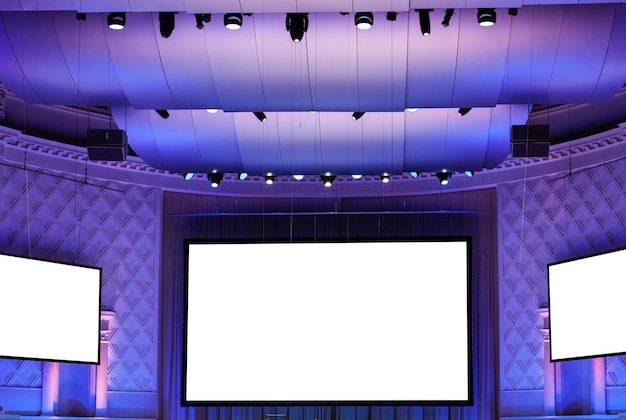 Photo screens in violet illuminated cinema theater