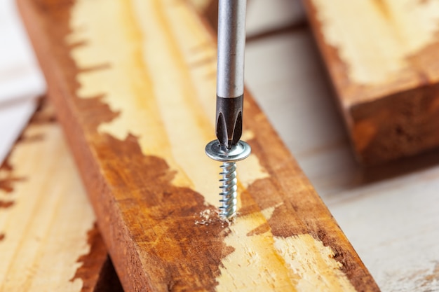 Photo screw screwed into a wooden bar