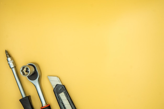 Photo screwdriver torque and knife isolated on cream background