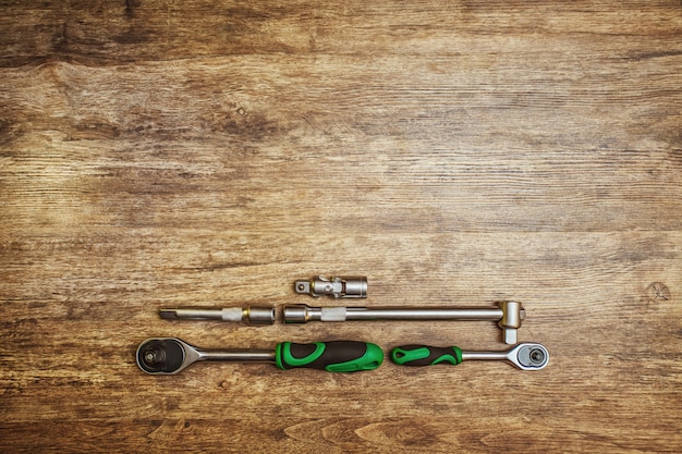 Screwdriver with ratchet.Set of different working tools on wooden background. 