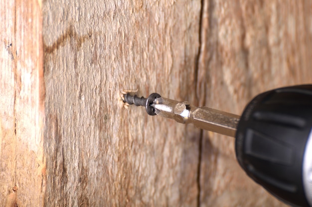 screwdriver on a wooden tablescrewed with screws