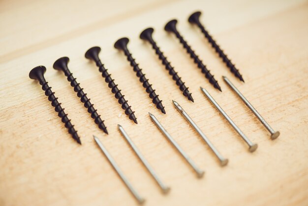 Screws near bolts on the wooden table