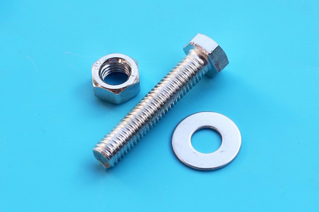 Screws and nuts on blue background