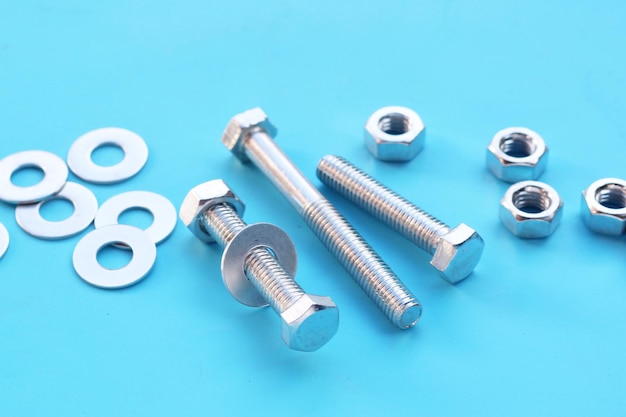 Screws and nuts on blue background