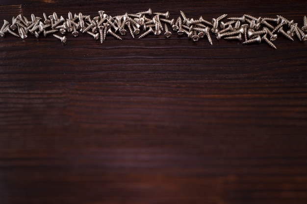 screws on a wooden background. copy space