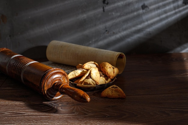 The Scroll of Esther and Purim Festival objects on a dark wooden table Rustic