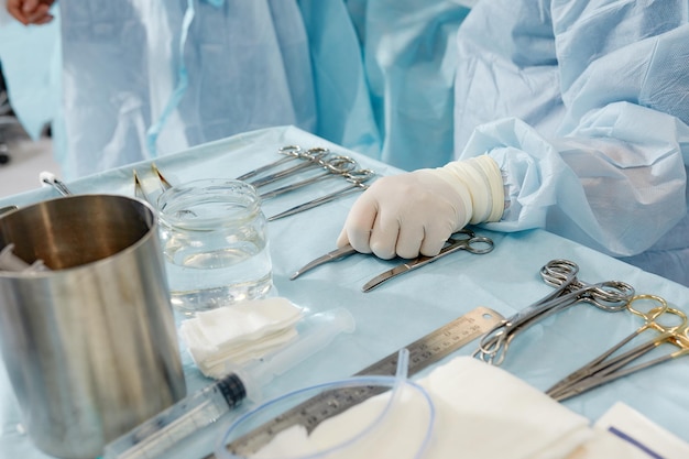 Scrub nurse preparing medical instruments for operation