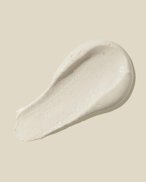 Scrub smear on a beige background Beauty texture Sample of a cosmetic product