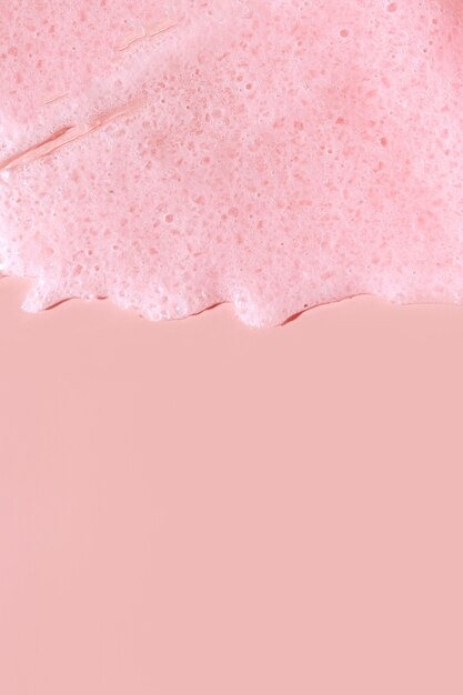 Scrub  smear on a pink background. Beauty texture. Sample of a cosmetic product.