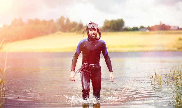 A scuba diver in a wet suit prepares