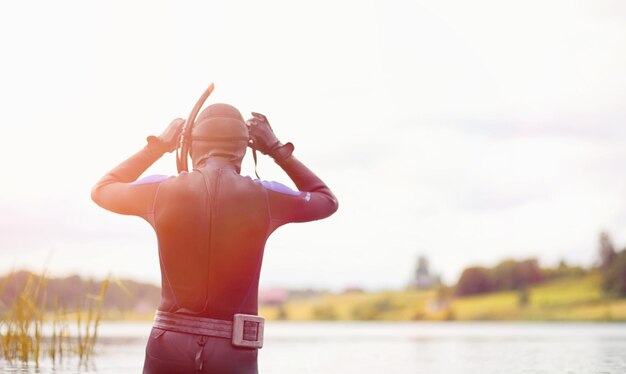 A scuba diver in a wet suit prepares