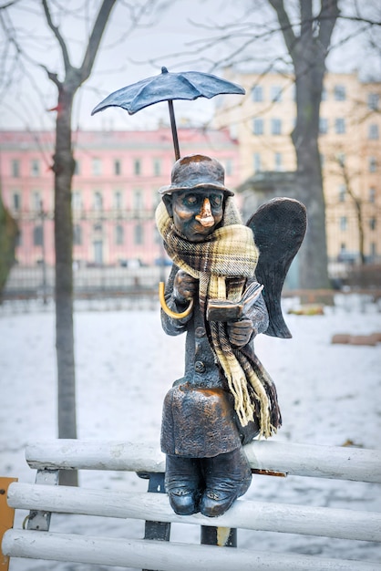 Sculpture of an angel in St. Petersburg in the Izmailovsky Garden near the Youth Theater on Fontanka on a cloudy winter day
