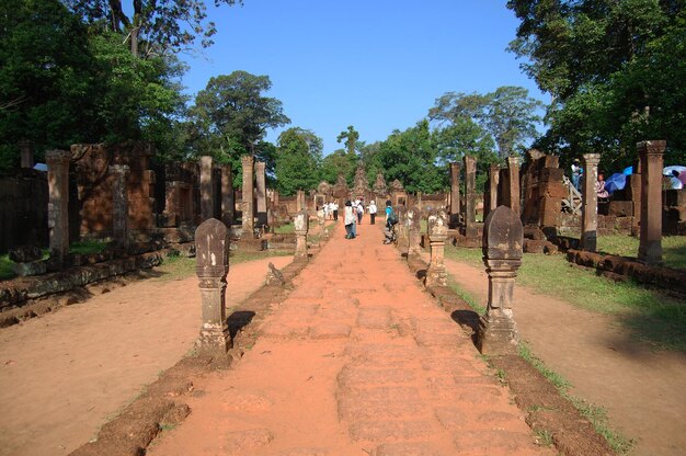 古代遺跡の彫刻彫刻アンティークの建物PrasatBanteaySreiまたはカンボジアの人々のためのアンコールワットのBanteaySrey寺院旅行者はシェムリアップカンボジアのアンコールトムで敬意を表して祈る