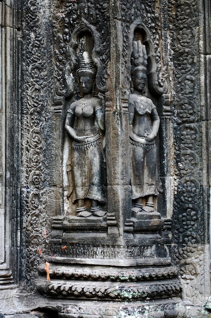 Sculpture carving figure apsaras or apsara angel deity female spirit of clouds waters and superb art of dancing in Prasat Ta Prohm or Ancestor Brahma temple of Angkor Thom Wat in Siem Reap Cambodia