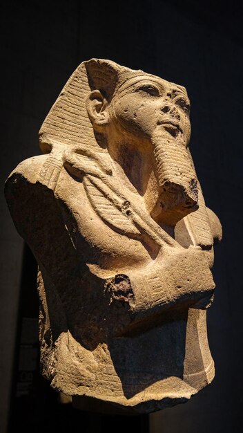 Photo sculpture of an egyptian deity made of stone displayed in a museum