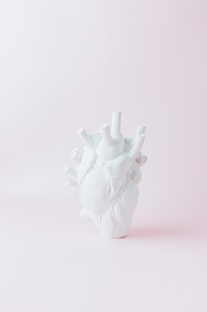 Sculpture heart on a pink background creative love valentines day concept