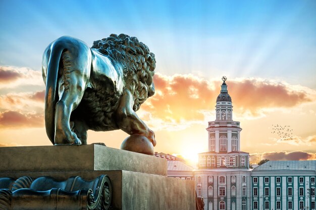 Sculpture of a lion on the Admiralteiskaya embankment in St. Petersburg opposite Kunstkamera on a summer evening