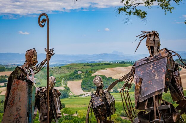 A sculpture of male figures made from steel set in fanjeaux
belvedere called le seignadou