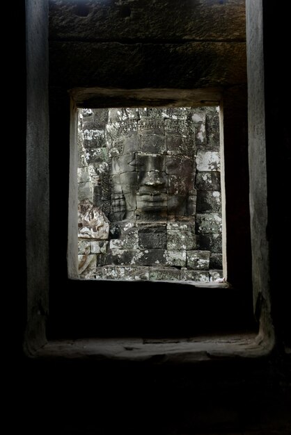 Sculpture seen through window in temple