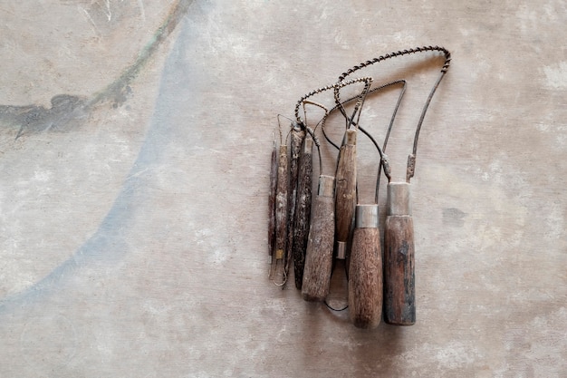 Sculpture tools. Art and craft tools on vintage wood background. Close-up.