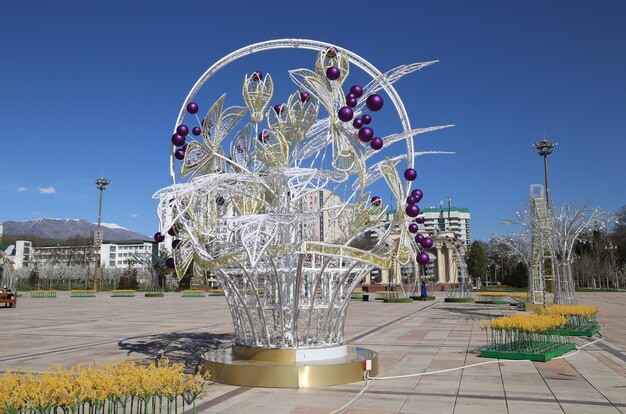 A sculpture of a tree with purple balls on it