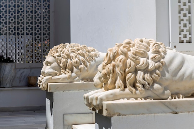 Photo sculpture of two marble lions lying at the entrance andros island cyclades greece