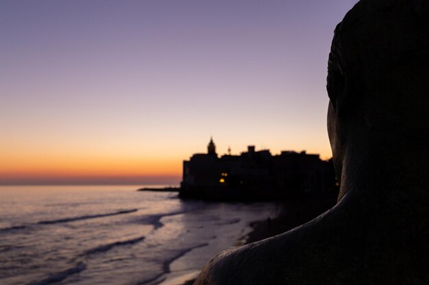 Sculpture of a woman by the sunset