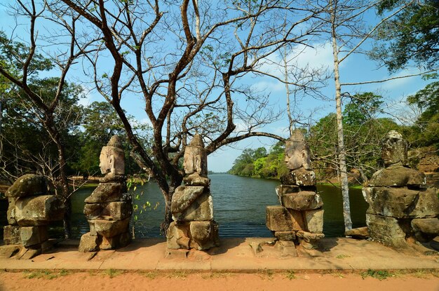 Sculptures spirits demons on bridge in South gate of Angkor Thom Cambodia Angkor Wat temple complex