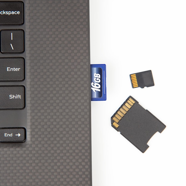사진 흰색 배경 전자 산업 및 정보 항목에 노트북 근처에 전자 데이터를 기록하기 위한 sd 메모리 카드