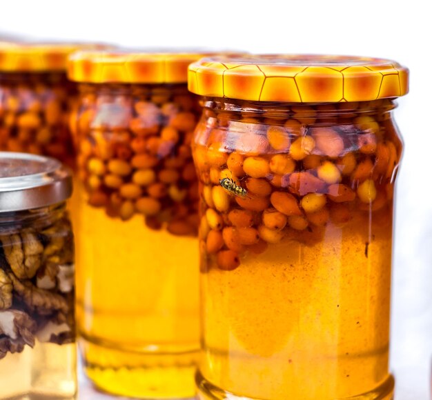 Sea buckthorn berries mixed with honey in the jar