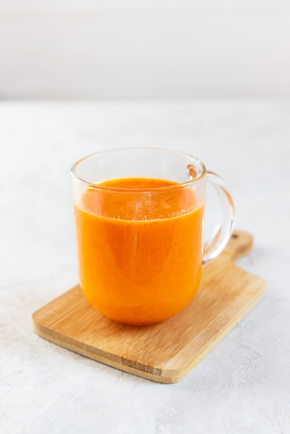 Sea buckthorn juice on a wooden board