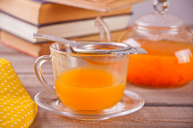 Sea buckthorn tea in a glass cup. Herbal vitamin tea.