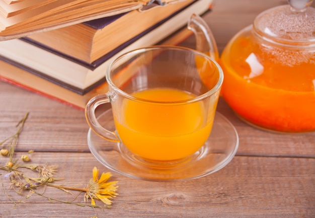 Sea buckthorn tea in a glass cup. Herbal vitamin tea.