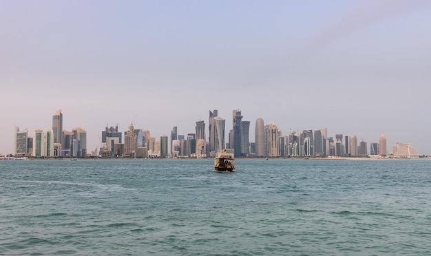 Sea and buildings in city against clear sky