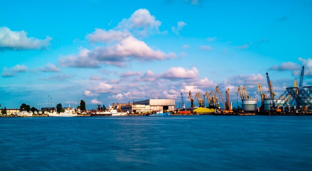 Sea by buildings against blue sky