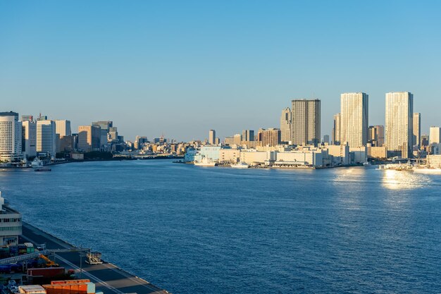 Sea by buildings against clear sky