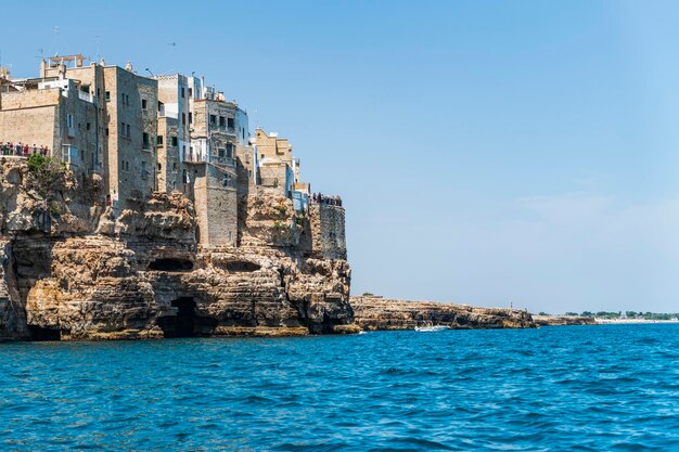 Sea by buildings against sky