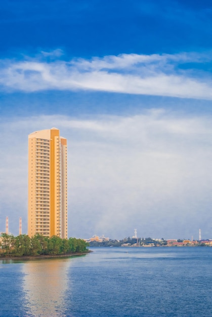 Sea by modern buildings against blue sky