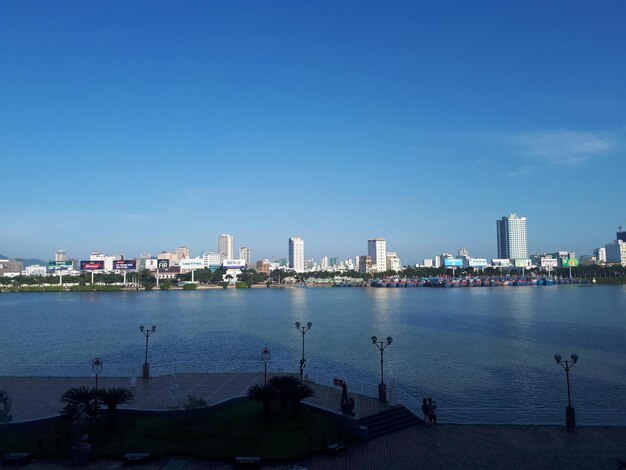 Sea and cityscape against sky