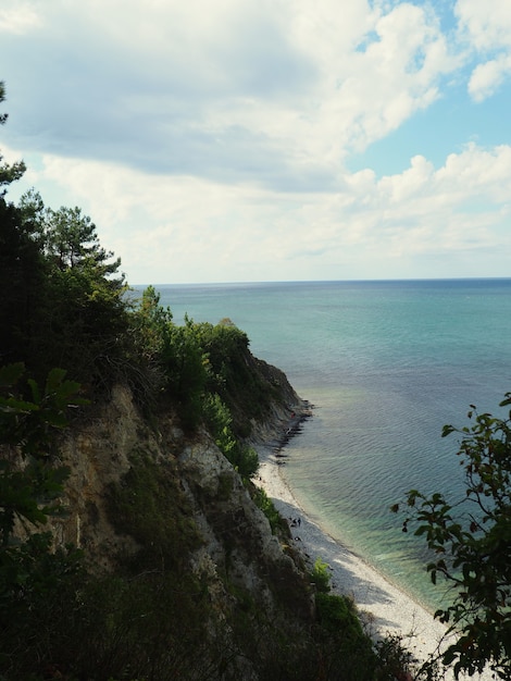 Sea cliff high angle view of cliff by sea during sunny day