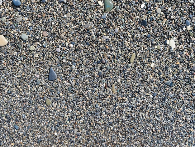 Sea coast Wet little pebbles on the beach