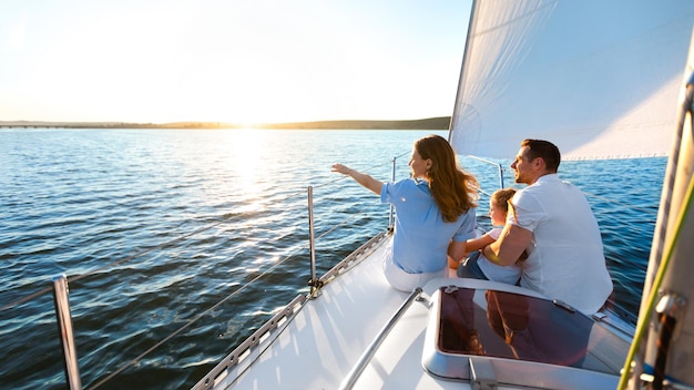 Sea Cruise. Family Sitting On Yacht Deck Sailing Across The Sea On Summer Vacation. Panorama, Copy Space