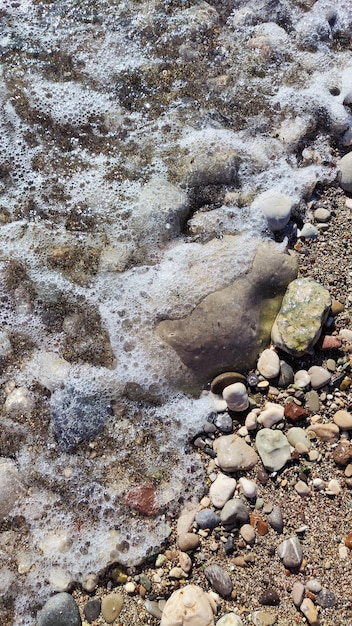 sea foam on pebbles